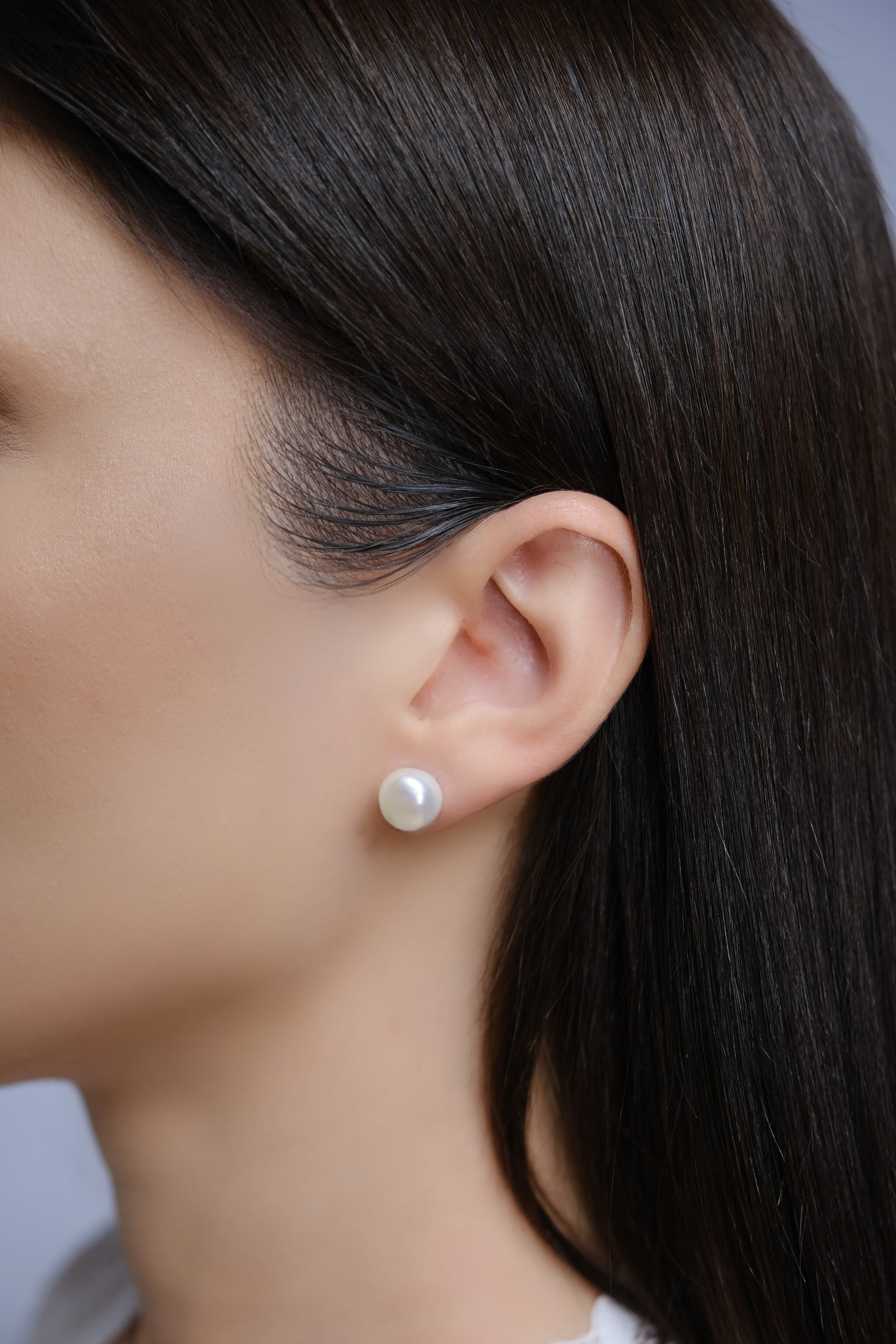 Model wearing Grace titanium pearl stud earrings for sensitive ears.