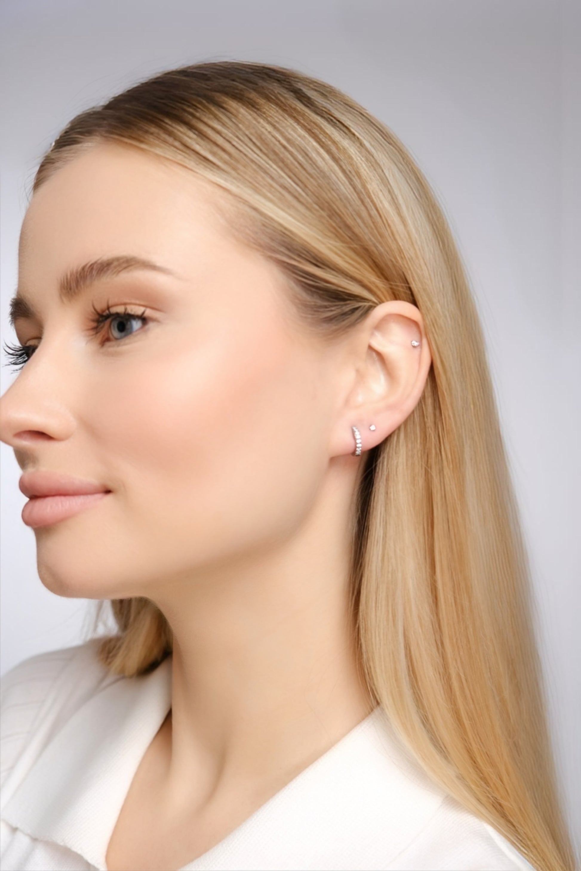 Olivia Classic Silver titanium huggie hoops worn on ear — medical grade titanium earrings for sensitive skin