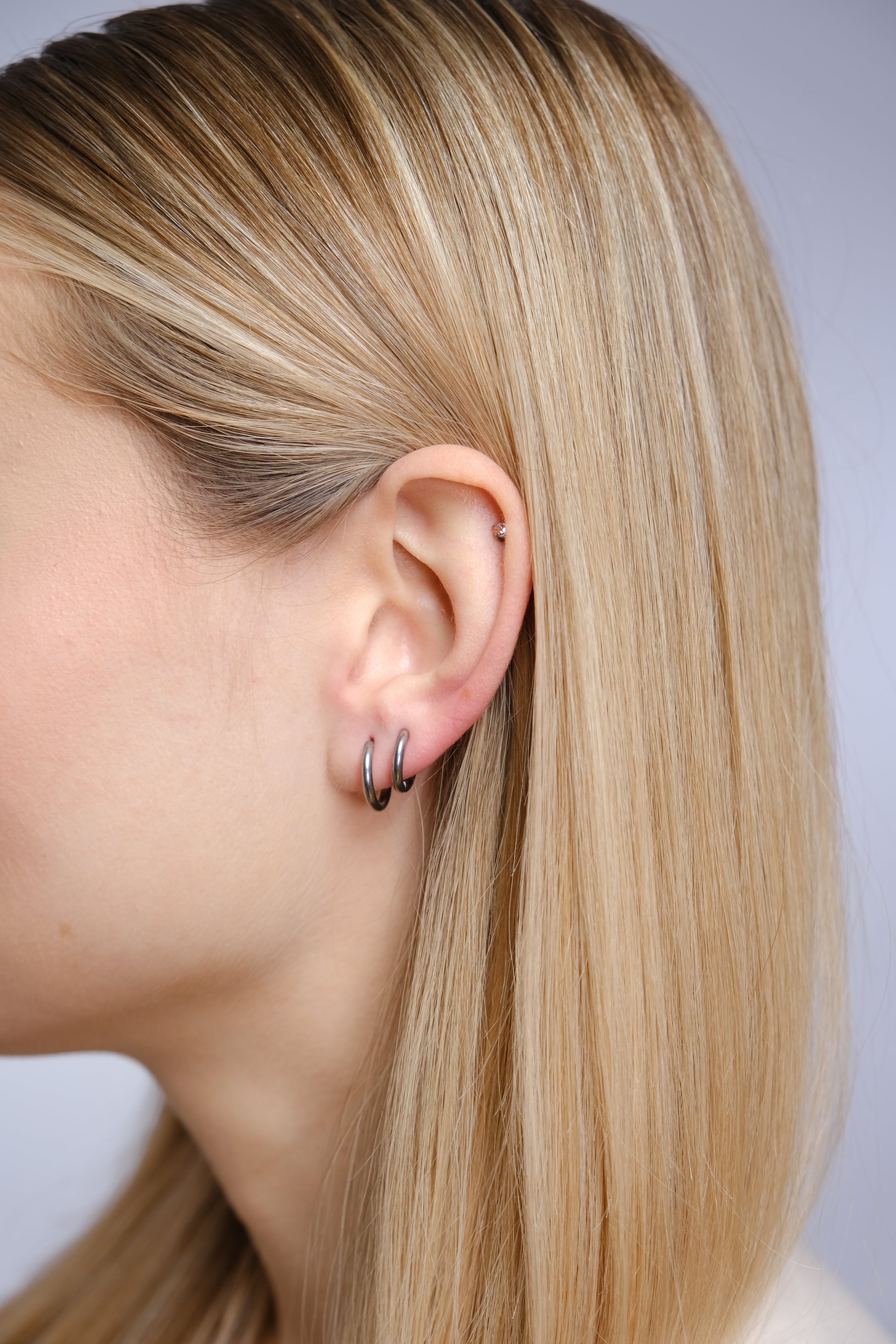 Halo 8mm Silver Huggie Hoop Earrings on Ear – Helix Piercing Jewelry Implant Grade Titanium
